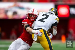 Nebraska Cornhusker defensive back Isaac Gifford (2) tackles Iowa Hawkeye running back Kaleb Johnson (2) in the second quarter during the football game on Thursday, November 24, 2023, in Lincoln, Neb. Photo by John S. Peterson.