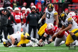 Nebraska Cornhusker offensive lineman Henry Lutovsky (59) reaches for the ball against the Iowa Hawkeyes in the third quarter during the football game on Thursday, November 24, 2023, in Lincoln, Neb. Photo by John S. Peterson.