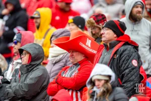 Nebraska Cornhusker fan watches the action on the field against the Iowa Hawkeyes in the fourt quarter during the football game on Thursday, November 24, 2023, in Lincoln, Neb. Photo by John S. Peterson.