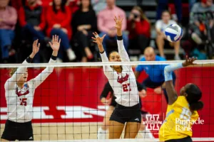 Nebraska Cornhuskers Andi Jackson (15) and Harper Murray (27) jump up to block Long Island Shark opposite Celine Mukura (15) in the second set during the first round of the NCAA volleyball championships on Friday, December 1, 2023, in Lincoln, Neb. Photo by John S. Peterson.
