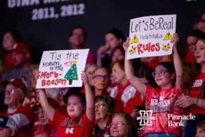Nebraska Cornhuskers fans holding their signs up at a break in the action against the Long Island Sharks during the first round of the NCAA volleyball championships on Friday, December 1, 2023, in Lincoln, Neb. Photo by John S. Peterson.