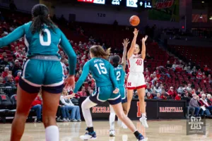 Nebraska Cornhusker center Alexis Markowski (40) makes a three point shot against UNC Wilmington Seahawk guard Taylor Henderson (2) in the first half during a college basketball game Tuesday, December 5, 2023, in Lincoln, Neb. Photo by John S. Peterson.
