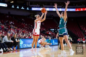 Nebraska Cornhusker guard Jaz Shelley (1) makes a three point shot against UNC Wilmington Seahawk guard McCall King (10) in the second half during a college basketball game Tuesday, December 5, 2023, in Lincoln, Neb. Photo by John S. Peterson.