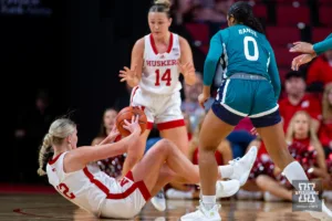 Nebraska Cornhusker forward Jessica Petrie (12) ends up with the loose ball and passes to Callin Hake in the first half agaisnt UNC Wilmington Seahawk guard Britany Range (0) during a college basketball game Tuesday, December 5, 2023, in Lincoln, Neb. Photo by John S. Peterson.