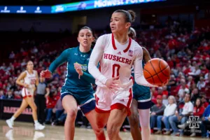 Nebraska Cornhusker guard Darian White (0) passes theb all against UNC Wilmington Seahawk guard Mary Ferrito (1) in the first half during a college basketball game Tuesday, December 5, 2023, in Lincoln, Neb. Photo by John S. Peterson.