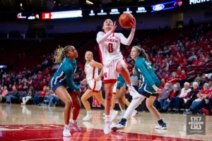 Nebraska Cornhusker guard Darian White (0) makes a lay up against UNC Wilmington Seahawk guard Mary Ferrito (1) in the second half during a college basketball game Tuesday, December 5, 2023, in Lincoln, Neb. Photo by John S. Peterson.