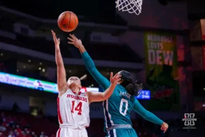Nebraska Cornhusker guard Callin Hake (14) drives in for a lay up against UNC Wilmington Seahawk guard Britany Range (0) in the first half during a college basketball game Tuesday, December 5, 2023, in Lincoln, Neb. Photo by John S. Peterson.