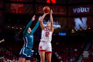 Nebraska Cornhusker forward Jessica Petrie (12) makes a lay up against UNC Wilmington Seahawk guard Mary Ferrito (1) in the first half during a college basketball game Tuesday, December 5, 2023, in Lincoln, Neb. Photo by John S. Peterson.