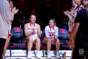 Nebraska Cornhusker guard Maddie Krull (42) smiles as center Alexis Markowski (40) is dancing in her seat beofre taking on the UNC Wilmington Seahawks during a college basketball game Tuesday, December 5, 2023, in Lincoln, Neb. Photo by John S. Peterson.