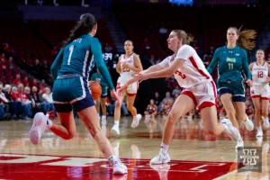 Nebraska Cornhusker guard Logan Nissley (2) makes a pass in the first quarter against UNC Wilmington Seahawk guard Mary Ferrito (1)  during a college basketball game Tuesday, December 5, 2023, in Lincoln, Neb. Photo by John S. Peterson.