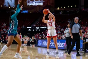 Nebraska Cornhusker guard Callin Hake (14) makes a three against the UNC Wilmington Seahawks in the first half during a college basketball game Tuesday, December 5, 2023, in Lincoln, Neb. Photo by John S. Peterson.