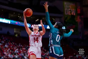 Nebraska Cornhusker guard Callin Hake (14) makes a lay up against UNC Wilmington Seahawk guard Britany Range (0) in the first half during a college basketball game Tuesday, December 5, 2023, in Lincoln, Neb. Photo by John S. Peterson.