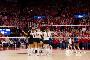 Nebraska Cornhuskers celebrate the win over the Georgia Tech Yellow Jackets in three sets during the third round in the NCAA Volleyball Championship match Thursday, December 7, 2023, Lincoln, Neb. Photo by John S. Peterson.
