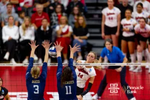 Nebraska Cornhusker Ally Batenhorst (14) spikes the ball against Georgia Tech Yellow Jackets Anna Boezi (3) and Larissa Mendes (11) in the third set during the third round in the NCAA Volleyball Championship match Thursday, December 7, 2023, Lincoln, Neb. Photo by John S. Peterson.