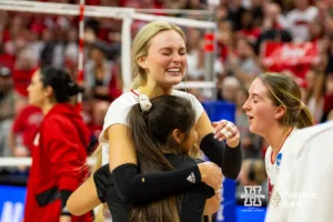 Nebraska Cornhuskers Ally Batenhorst (14) and Lexi Rodriguez (8) embrace celebrating the win over the Arkansas Razorbacks in four sets during the Regional Championship match in the NCAA Volleyball Championship Thursday, December 7, 2023, Lincoln, Neb. Photo by John S. Peterson.
