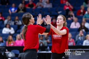 Nebraska Cornhusker Merritt Beason (13) and Lindsay Krause give each other high fives during open practice before the NCAA Semi-Finals, Wednesday, December 13, 2023, Tampa, Florida. Photo by John S. Peterson.