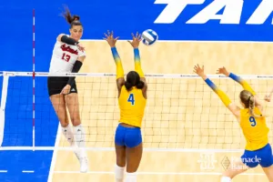 Nebraska Cornhusker outside hitter Merritt Beason (13) spikes the ball against Pittsburgh Panther outside hitter Torrey Stafford (4) and middle blocker Emma Monks (9) in the second set during the NCAA Semi-Finals, Thursday, December 14, 2023, Tampa, Florida. Photo by John S. Peterson.