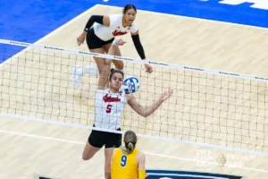 Nebraska Cornhusker middle blocker Bekka Allick (5) spikes the ball down against Pittsburgh Panther middle blocker Emma Monks (9) in the second set during the NCAA Semi-Finals, Thursday, December 14, 2023, Tampa, Florida. Photo by John S. Peterson.