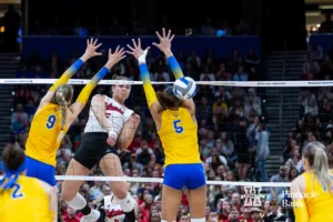Nebraska Cornhusker middle blocker Bekka Allick (5) scores a point against Pittsburgh Panther middle blocker Emma Monks (9) and Olivia Babcock in the third set during the NCAA Semi-Finals, Thursday, December 14, 2023, Tampa, Florida. Photo by John S. Peterson.
