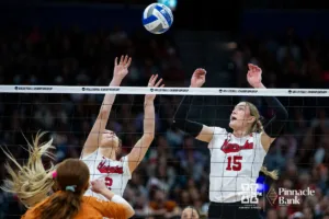 Nebraska Cornhuskers setter Bergen Reilly (2) and middle blocker Andi Jackson (15) reach to trying block the spike from the Texas Longhorns in the second set during the NCAA Finals on Sunday, December 17, 2023, in Tampa, Florida. Photo by John S. Peterson.