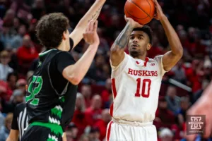 Nebraska Cornhusker guard Jamarques Lawrence (10) makes a three point shot against North Dakota Fighting Hawk guard Treysen Eaglestaff (52) in the first half  during a college basketball game Wednesday, December 20, 2023, in Lincoln, Nebraska. Photo by John S. Peterson.