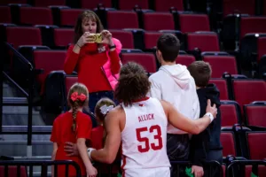 Nebraska Cornhusker forward Josiah Allick (53) poses with some kids for a q;uick photo before a college basketball game against the South Carolina State Bulldogs on Friday, December 29, 2023, in Lincoln, Nebraska. Photo by John S. Peterson.