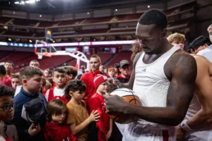 Nebraska Cornhusker forward Juwan Gary (4) signs autographs for the kids after the win over the South Carolina State Bulldogs during a college basketball game on Friday, December 29, 2023, in Lincoln, Nebraska. Photo by John S. Peterson.