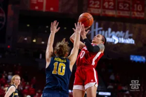 Nebraska Cornhusker guard Darian White (0) makes a lay up against Michigan Wolverine guard Jordan Hobbs (10) in the first quarter during a college basketball game on Wednesday, January 17, 2024, in Lincoln, Nebraska. Photo by John S. Peterson.