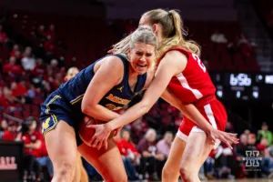 Nebraska Cornhusker forward Natalie Potts (22) and Michigan Wolverine forward Chyra Evans (22) fight for the ball in the first quarter during a college basketball game on Wednesday, January 17, 2024, in Lincoln, Nebraska. Photo by John S. Peterson.