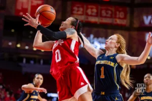 Nebraska Cornhusker guard Darian White (0) makes a lay up against Michigan Wolverine guard Lauren Hansen (1) in the first half during a college basketball game on Wednesday, January 17, 2024, in Lincoln, Nebraska. Photo by John S. Peterson.