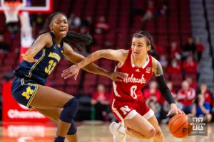 Nebraska Cornhusker guard Darian White (0) dribbles the ball against Michigan Wolverine forward Taylor Williams (33) in the first half during a college basketball game on Wednesday, January 17, 2024, in Lincoln, Nebraska. Photo by John S. Peterson.