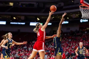 Nebraska Cornhusker guard Callin Hake (14) makes a lay up against Michigan Wolverine forward Taylor Williams (33) in the second half during a college basketball game on Wednesday, January 17, 2024, in Lincoln, Nebraska. Photo by John S. Peterson.