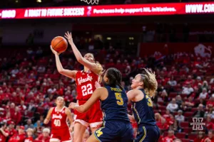 Nebraska Cornhusker forward Natalie Potts (22) makes a lay up against Michigan Wolverine guard Laila Phelia (5) and guard Elise Stuck (30) in the second half during a college basketball game on Wednesday, January 17, 2024, in Lincoln, Nebraska. Photo by John S. Peterson.
