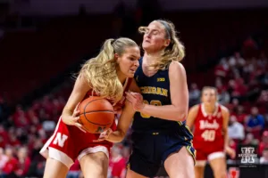 Nebraska Cornhusker forward Natalie Potts (22) drives to the basket against Michigan Wolverine guard Elise Stuck (30) in the second half during a college basketball game on Wednesday, January 17, 2024, in Lincoln, Nebraska. Photo by John S. Peterson.