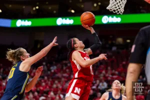 Nebraska Cornhusker guard Darian White (0) makes a lay up against Michigan Wolverine guard Jordan Hobbs (10) in the second half during a college basketball game on Wednesday, January 17, 2024, in Lincoln, Nebraska. Photo by John S. Peterson.