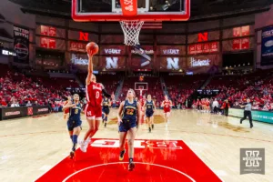 Nebraska Cornhusker guard Darian White (0) makes a lay up against Michigan Wolverine forward Chyra Evans (22) in the first half during a college basketball game on Wednesday, January 17, 2024, in Lincoln, Nebraska. Photo by John S. Peterson.