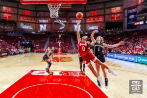 Nebraska Cornhusker guard Darian White (0) makes a lay up against Michigan Wolverine guard Lauren Hansen (1) in the first half during a college basketball game on Wednesday, January 17, 2024, in Lincoln, Nebraska. Photo by John S. Peterson.