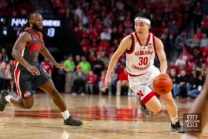 Nebraska Cornhusker guard Keisei Tominaga (30) drives the lane against Ohio State Buckeye guard Bruce Thornton (2) in the first half during a college basketball game on Tuesday, January 23, 2024, in Lincoln, Nebraska. Photo by John S. Peterson.
