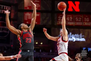 Nebraska Cornhusker guard Keisei Tominaga (30) makes a lay up against Ohio State Buckeye forward Zed Key (23) in the first half during a college basketball game on Tuesday, January 23, 2024, in Lincoln, Nebraska. Photo by John S. Peterson.