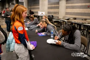 Omaha Supernovas Nia Kai Reed (14) signs her autograph for a young girl after the first professional volleyball match in the United States on Wednesday, January 24, 2024, in Omaha, Nebraska. Photo by John S. Peterson.