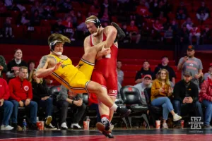 Nebraska Cornhusker Nash Hutmacher sweeps the leg for a takedown against the Wyoming Cowboys during a college wrestling match on Saturday, January 6, 2024, in Lincoln, Nebraska. Photo by John S. Peterson.
