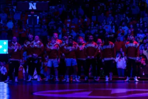 Nebraska Cornhuskers standing for the National Anthem before taking the Iowa Hawkeyes during a college wrestling march on Friday, January 12, 2024, in Lincoln, Nebraska. Photo by John S. Peterson.