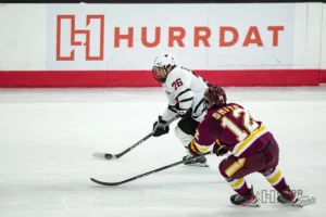 Omaha forward Brock Bremer (26) moves the puck down the ice against Minn. Duluth forward Jack Smith (12) in the first period during a college hockey match on Friday, February 2, 2024, in Omaha, Nebraska. Photo by John S. Peterson.