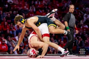 Nebraska Cornhusker No. 7 Brock Hardy (13-5) tries to roll Michigan Wolverine No. 4 Dylan Ragusin (20-0) off during a college wrestling match on Friday, February 9, 2024, in Lincoln, Nebraska. Photo by John S. Peterson.