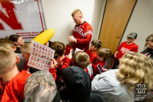 Nebraska Corhusker Nash Hutmacher signs autographs for the kids after a college wrestling match against the Michigan Wolverines on Friday, February 9, 2024, in Lincoln, Nebraska. Photo by John S. Peterson.