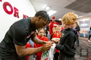 Nebraska Corhusker Antrell Taylor signs autographs for the kids after a college wrestling match against the Michigan Wolverines on Friday, February 9, 2024, in Lincoln, Nebraska. Photo by John S. Peterson.