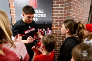 Nebraska Corhusker Lenny Pinto signs autographs for the kids after a college wrestling match against the Michigan Wolverines on Friday, February 9, 2024, in Lincoln, Nebraska. Photo by John S. Peterson.