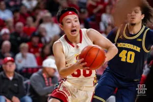Nebraska Cornhusker guard Keisei Tominaga (30) drives to the basket against Michigan Wolverine guard George Washington III (40) in the first half during a college basketball game on Saturday, February 10, 2024, in Lincoln, Nebraska. Photo by John S. Peterson.