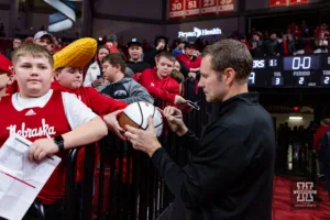 Nebraska Cornhusker head coach Fred Hoiberg signs an autograph after the win over the Michigan Wolverines during a college basketball game on Saturday, February 10, 2024, in Lincoln, Nebraska. Photo by John S. Peterson.