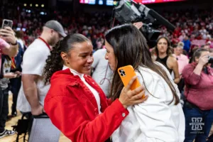 Nebraska Cornhusker head coach Amy Williams gets a hug from her daughter Kennadi after the win over the Iowa Hawkeyes during a college basketball game on Sunday, February 11, 2024, in Lincoln, Nebraska. Photo by John S. Peterson.